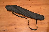 Soft black SLIK-branded carrying case with shoulder strap