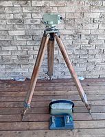 Full view of level mounted on tripod with open carrying case beneath