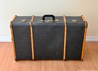 Exterior front view of closed suitcase trunk upright