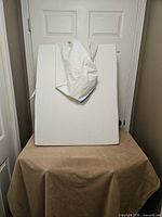 Front view of white memory foam wedge pillow with cover partially removed