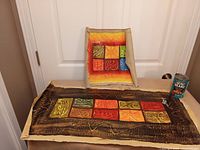 Overview of horizontal and square canvas pieces with can for scale