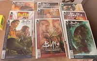 Multiple Buffy the Vampire Slayer comics in protective sleeves displayed on table
