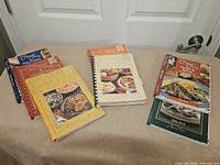 Company’s Coming and other cookbooks on beige cloth (part of lot)