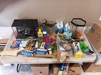 Overall view of three aquariums and accessories spread on table