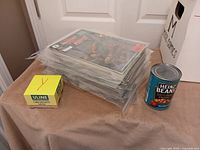 Stack of bagged & boarded comics beside reference objects