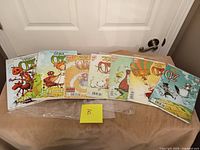 Seven Oz series comics laid out on table