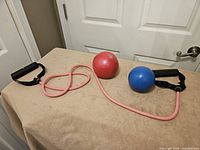 Resistance tube and two weighted balls on table