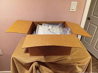 Closed cardboard box with contents visible