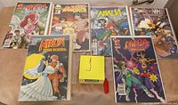 Seven comics laid out showing variety of covers and bag/board condition