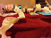 Group view of ribbon spools and seam binding packages on table