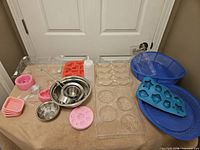 Overview of molds, bowls, ladle, squeeze bottle, blue tubs