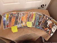 All comics spread out on table, bagged, quantity visible