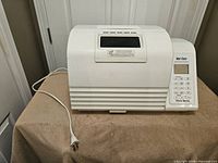 Front view of closed West Bend bread maker with power cord
