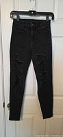 Front view of black distressed jegging jeans