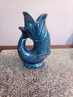 Front view of blue teal fish gurgle jug