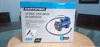 Box front displaying Certified 12V direct-drive analog air compressor image and specifications