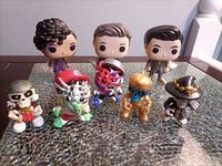 Group shot of all eight vinyl figures on glass surface