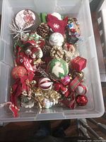 top view of bin showing mixed ornaments, pinecones, ribbons