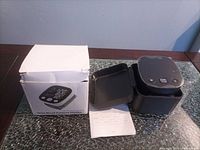 monitor, case, manual and box on glass surface