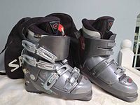 Front angled view of both boots with carry bag visible