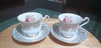 Two Paragon teacups with matching saucers on table