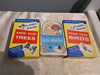 Front view of the three boxed flash card sets