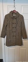 Front view of olive houndstooth double-breasted coat on hanger