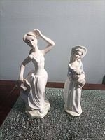 Front view of both Tengra figurines