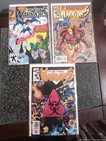 All three bagged and boarded New Warriors comics laid out