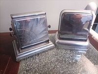 Front view of both chrome toasters side by side