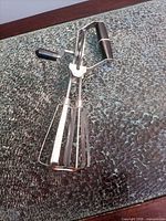 Top view of full egg beater showing handle, crank knob and dual beaters