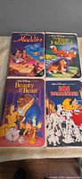 Front view of four Walt Disney VHS clamshell cases