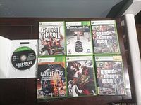 Front view of six cased games and loose Call of Duty disc