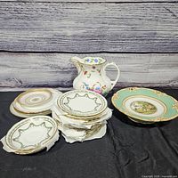 Group view of pitcher, plates, bowl