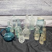 Entire lot showing all bottles, jar, pitcher, vase