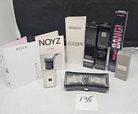 All items grouped: fragrance sample cards, Jo Malone mini, Givenchy lip tint boxes, Benefit mascara box, leather holder, grey boxed item