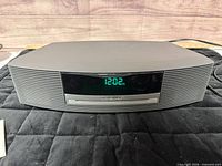 Front view showing display, CD slot, grille