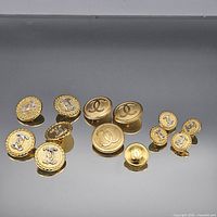 Group view of all eleven Chanel gold-tone shank buttons