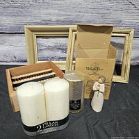 Group shot of all items: pillar candle pack, metallic candle, Willow Tree figurine with box, two wood frames, wood organizer