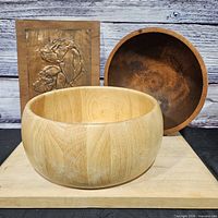 Two of the wooden bowls shown front and side for shape and size reference