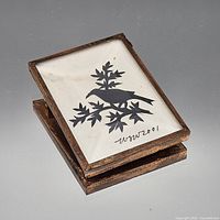 Front view showing framed bird silhouette under glass