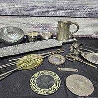 Full lot overview showing bowls, trays, pitcher, utensils, coasters and figurines