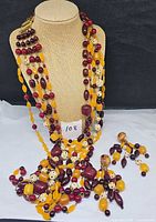 Necklace displayed on bust with earrings shown below