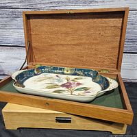 Tray inside open wooden box showing both items