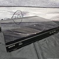 Overall view of Sony PS-LX300USB turntable with dust cover closed and power cord visible