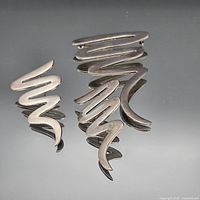 Brooch and one earring front view showing abstract design