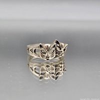 Front view showing dual cat face design and band