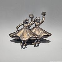 Front view of sterling silver dancers brooch