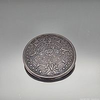 Front view of round Aztec calendar brooch