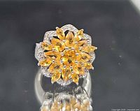 Top view showing orange marquise stones and clear stone halo